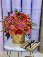 Round box with orange and red autumn flowers