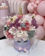 Unicorn Elie arrangement with pastel flowers and balloons