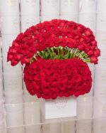 Box densely packed with red roses
