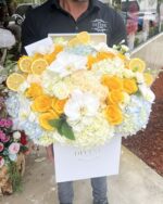 Yellow and white flowers in a light blue box