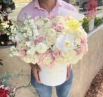 Round box with cream and pastel flowers