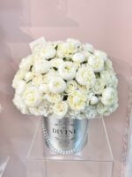 Round box filled with white roses