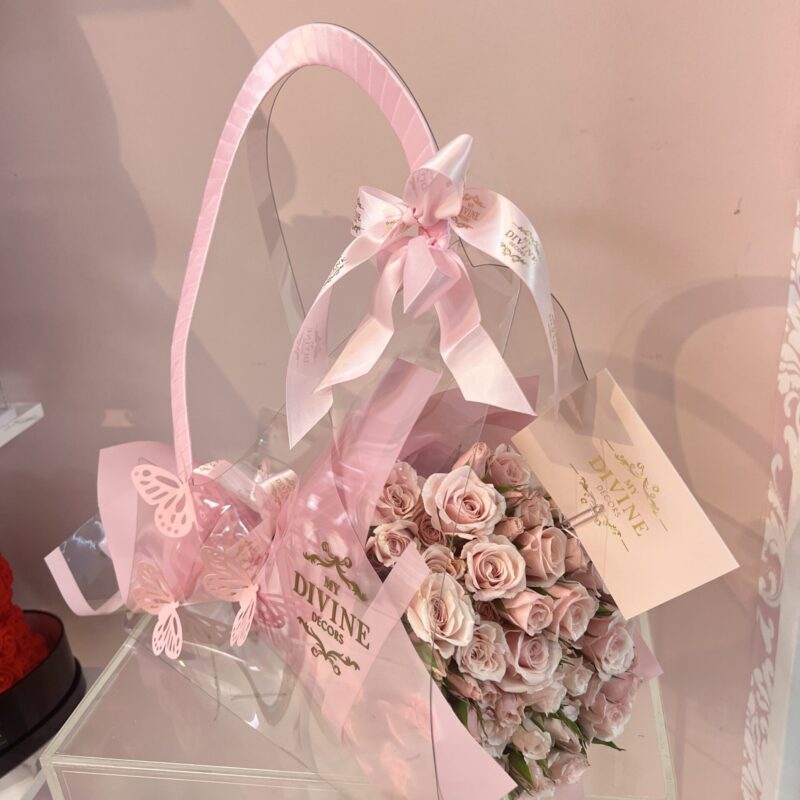 Bouquet presented in a transparent Divine carry bag