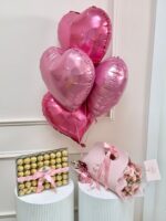 Pink heart balloons, Ferrero chocolates and a pink spray rose bouquet
