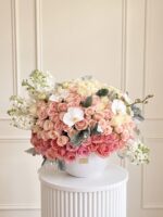 Lovely in Vase XL: peach and cream roses, white stock and orchids in a white vase