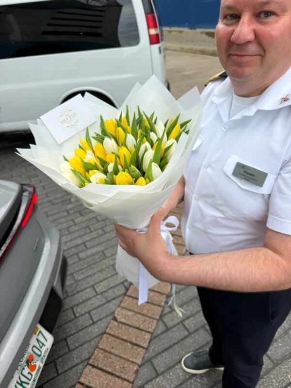 Ship officer at PortMiami holding a bouquet of yellow and white tulips from My Divine Decors