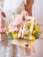 Beautiful floral arrangement in a pastel gift bag for special occasions, showcasing elegant bridal or event decor from My Divine Decors.