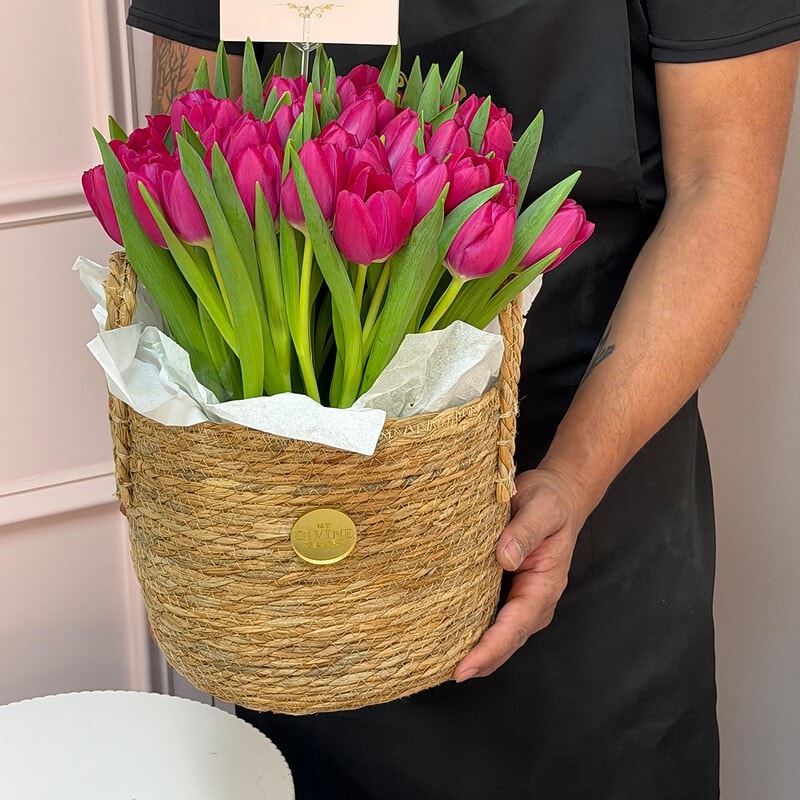 Woven basket filled with pink tulips