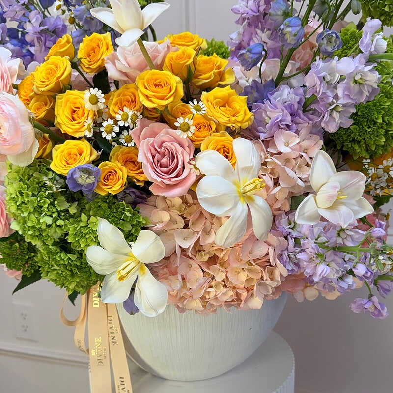 Spring blooms arranged in a Positano style vase