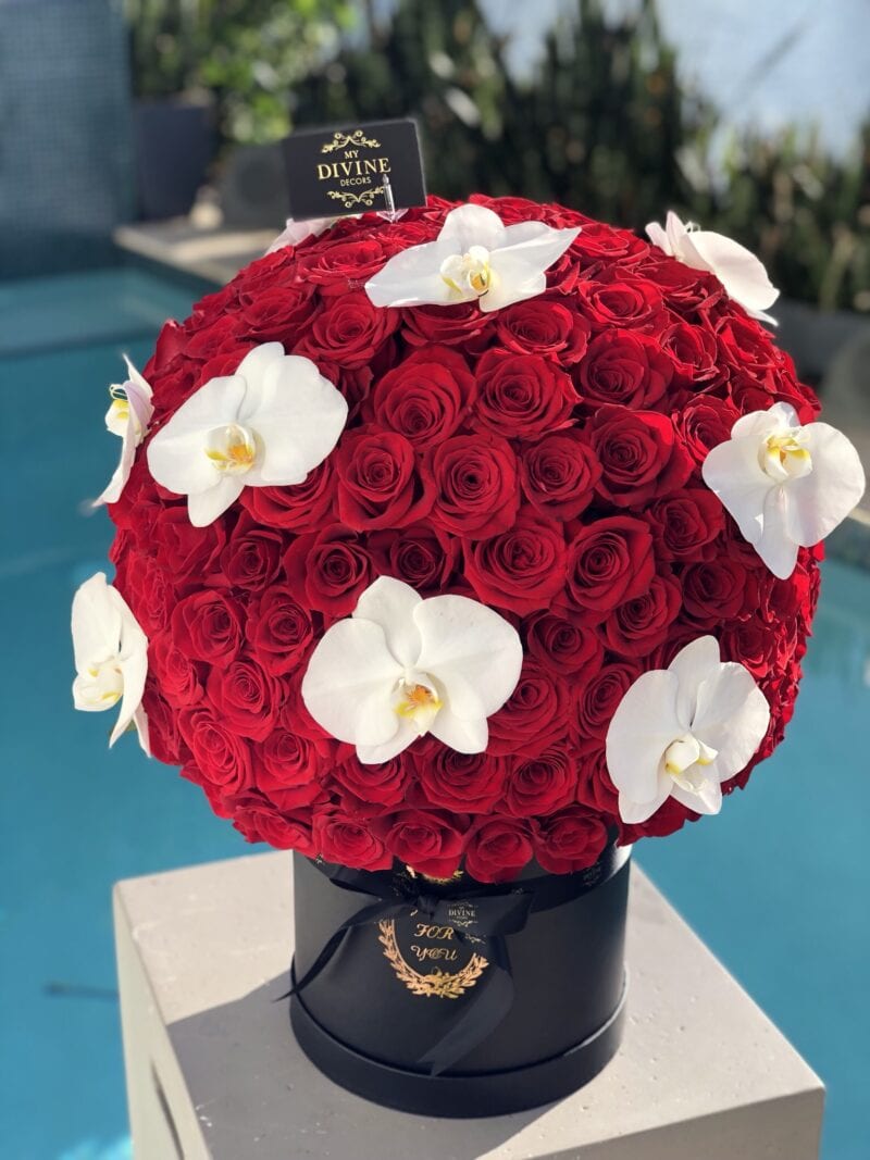 Red rose sphere with white phalaenopsis orchids in a black My Divine Decors hat box