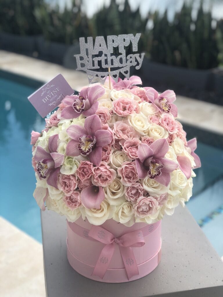 Pink and white birthday flower box with cymbidium orchids by My Divine Decors