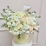 Cream and ivory flower hat box with a plush goose and pearl detail