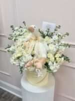 Side view of the buttercream blooms hat box with plush goose