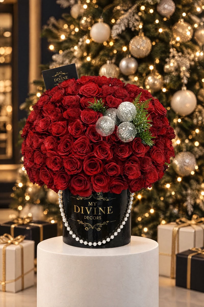 Red roses in a black My Divine Decors hat box at the boutique on a Christmas night