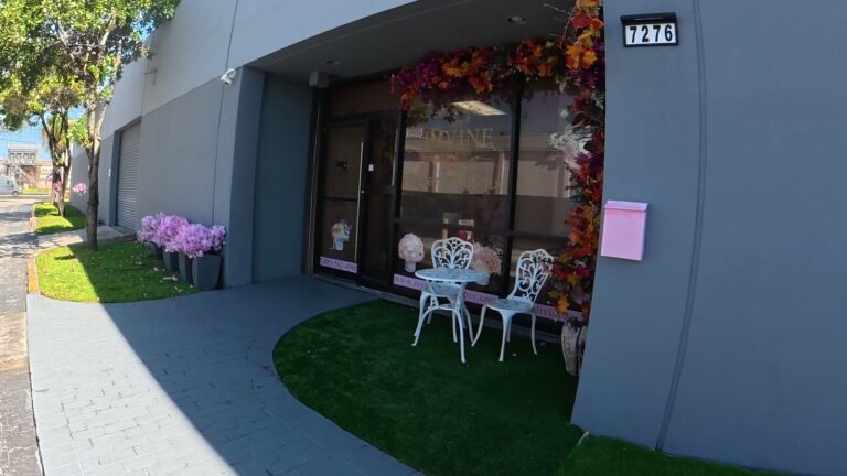 Boutique entrance at 7276 NW 58th St with the floral arch