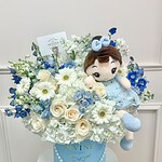 Blue hat box of white and blue fresh flowers with a plush doll