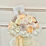 Preserved roses and hydrangea in ivory, champagne and blush tones in a cream box
