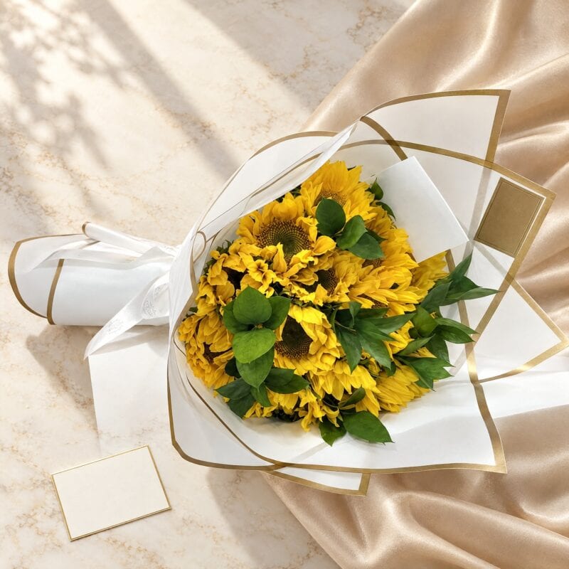 Sunflower Love Hand Bouquet in white and gold wrap on champagne silk