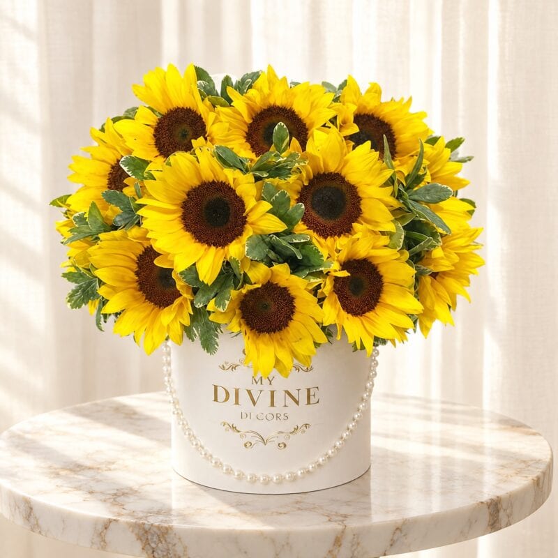 Sunshine Sunflower HatBox with pearl strand on a marble pedestal table