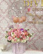 Anna Hot Air Balloon by My Divine Decors: clear bubble balloon over a lilac box of pink roses, ranunculus, white hydrangeas and orchids