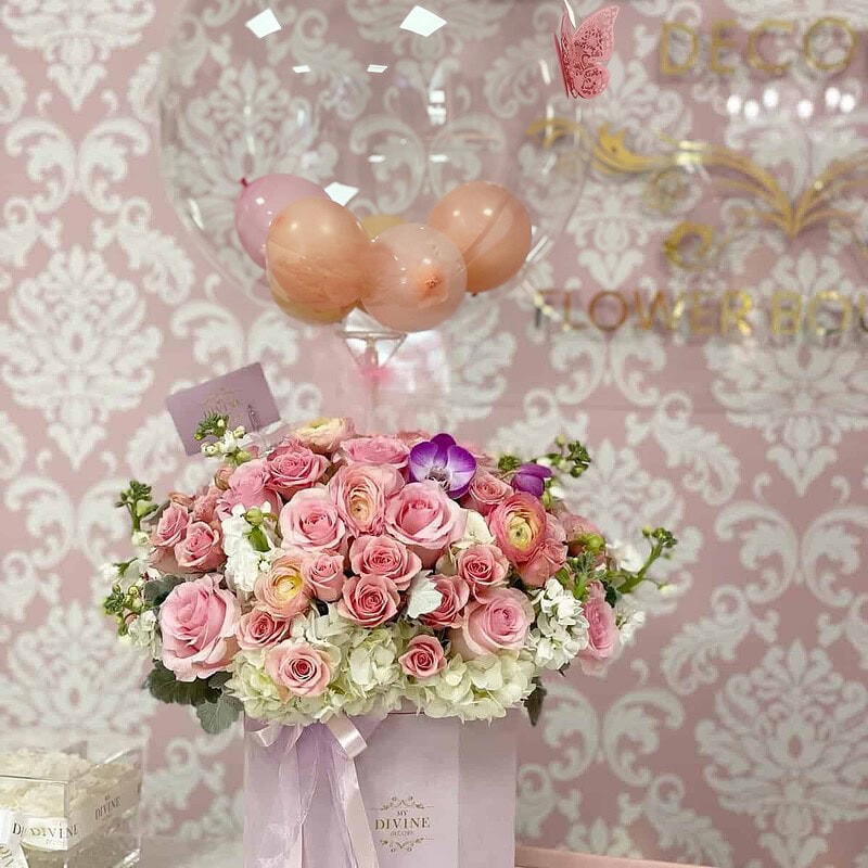 Anna Hot Air Balloon by My Divine Decors: clear bubble balloon over a lilac box of pink roses, ranunculus, white hydrangeas and orchids