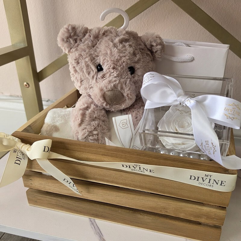 Wooden baby crate with snug teddy bear, blanket and white preserved rose in acrylic box