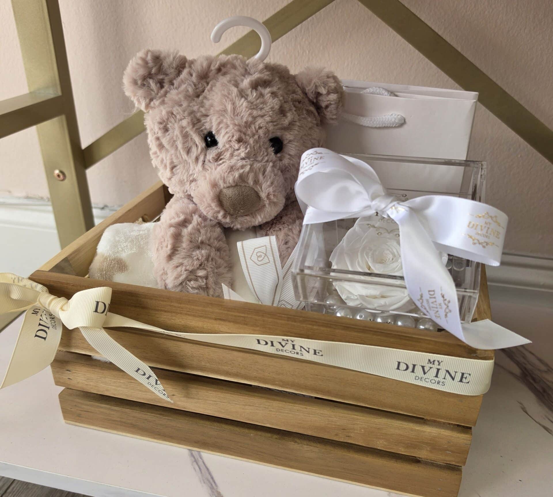 Baby Crate, Teddy, Blanket & White Rose Wooden baby crate with snug teddy bear, blanket and white preserved rose in acrylic box