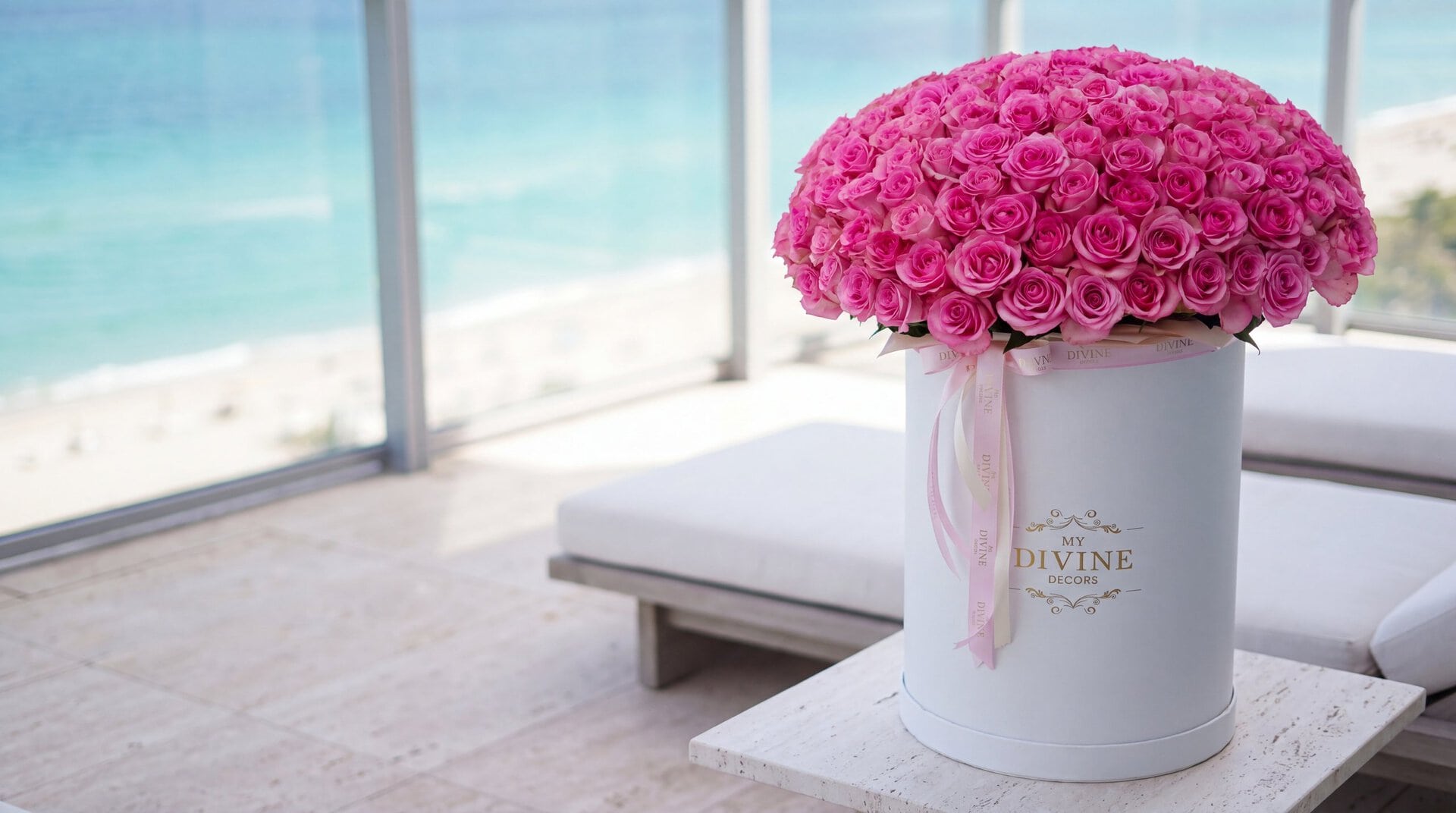 The 200 roses tall grand signature box by My Divine Decors with hot pink roses on an oceanfront terrace in Bal Harbour overlooking the Atlantic