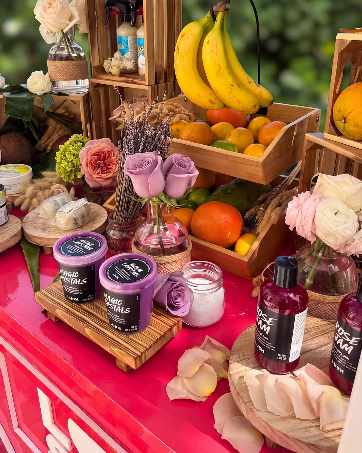 Brand products displayed on the flower cart with lavender roses, ranunculus and fresh fruit