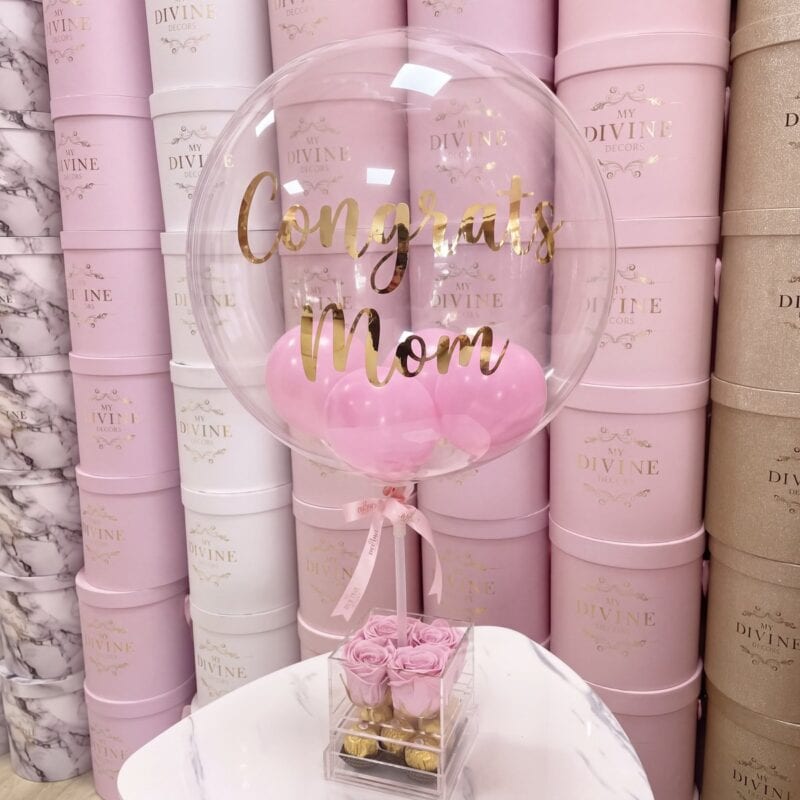 Congrats Mom bubble balloon over 4 pink preserved roses in an acrylic box with Ferrero Rocher, My Divine Decors