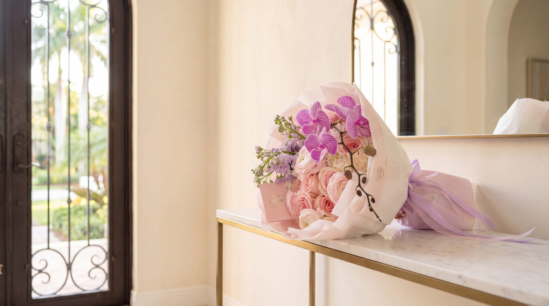 Cynthia hand bouquet by My Divine Decors with pink roses, hydrangeas, lilac stock and purple orchids on a marble console in a Mediterranean-style home in Miami Gardens