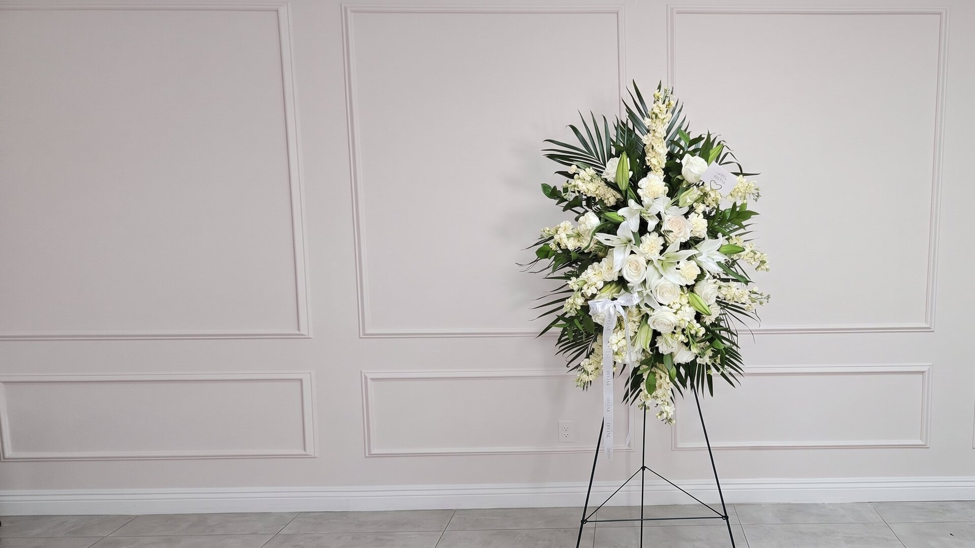 Elegant Funeral Standing Spray by My Divine Decors: white lilies, roses and stock with palm leaves on an easel
