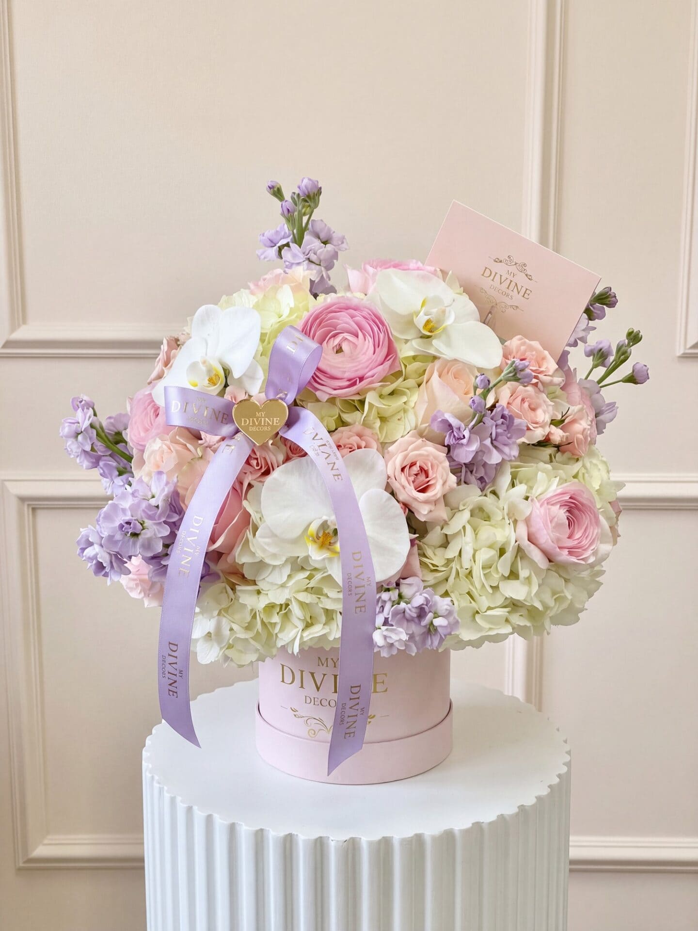 Hanna medium signature box: pink ranunculus, blush roses, white orchids, hydrangea and lavender stock with a lilac ribbon Hanna medium signature box: pink ranunculus, blush roses, white orchids, hydrangea and lavender stock with a lilac ribbon