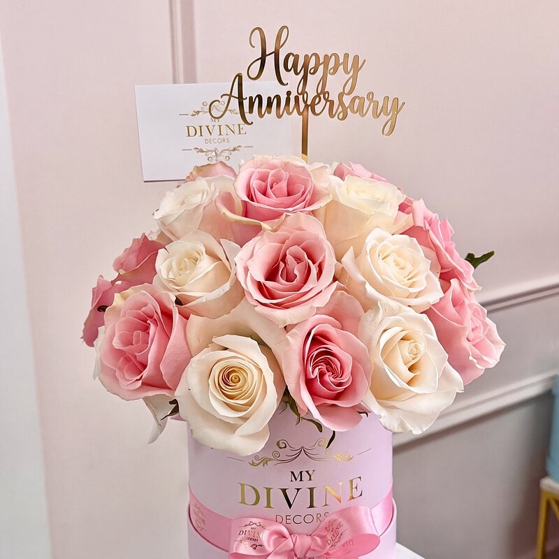 25 pink and white roses in the My Divine Decors medium signature hat box with a gold Happy Anniversary topper