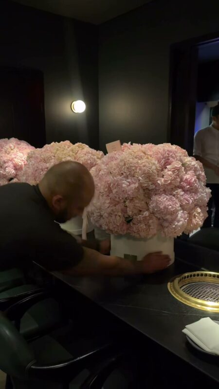 A hydrangea box set on a dark dinner table