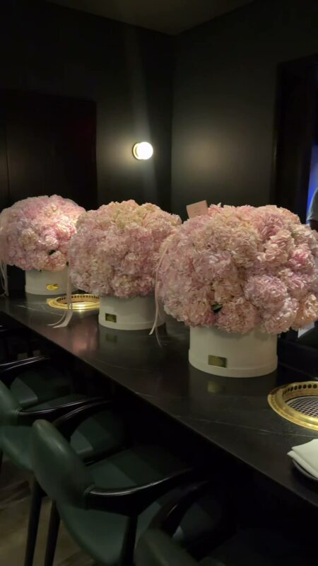 Hydrangea boxes down a dark dinner table in the Design District