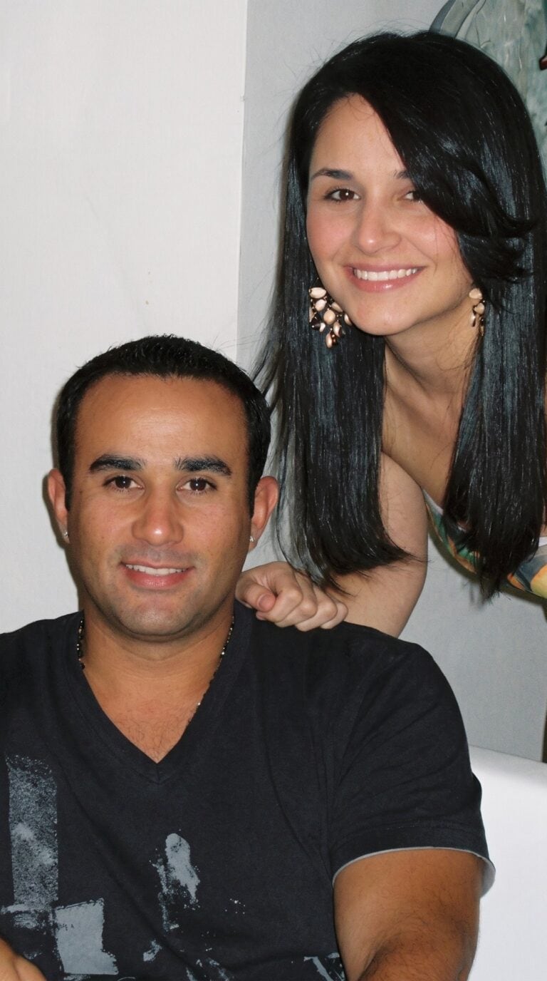 Nelson seated with Jessica behind him, smiling