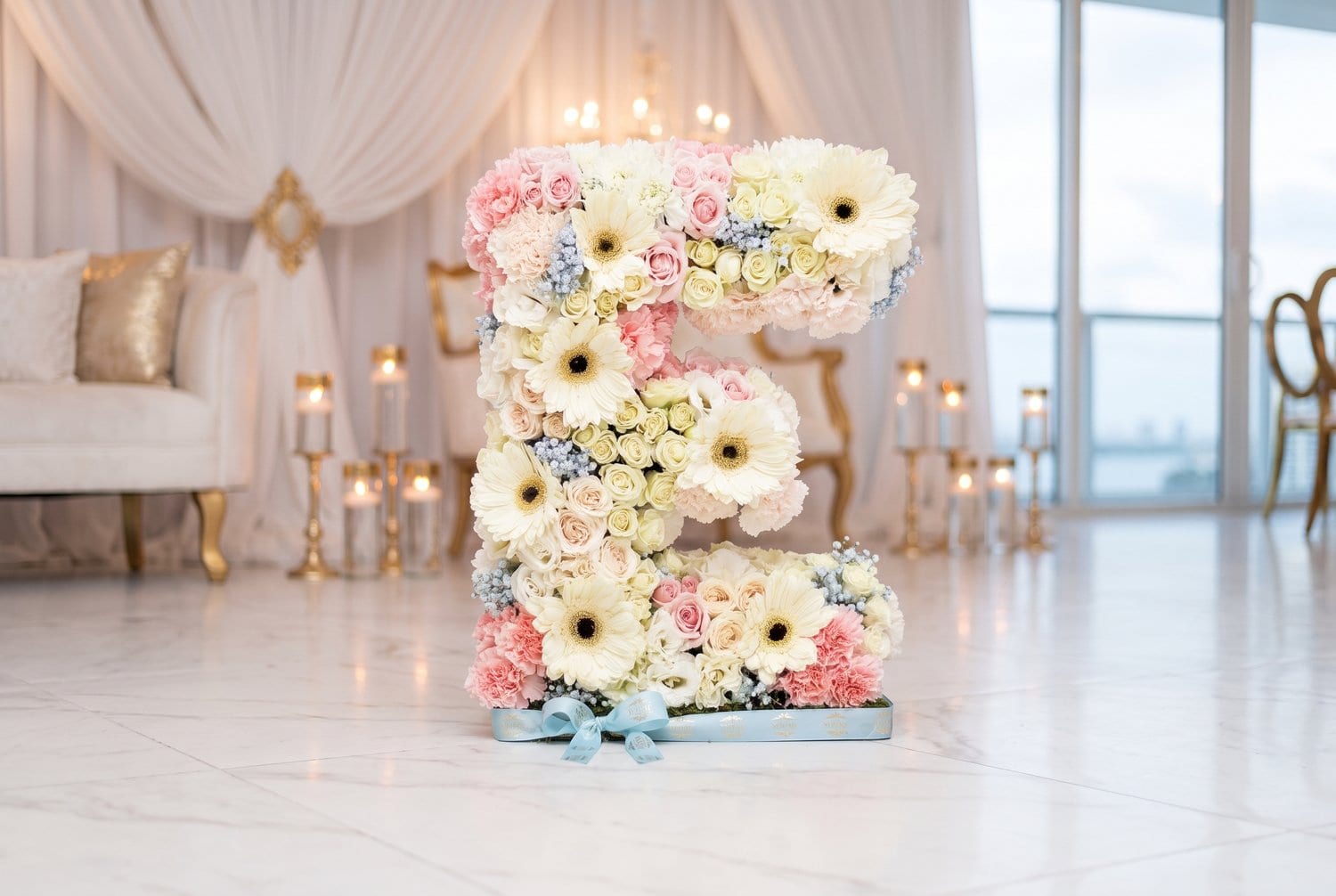 Standing letter E in gerberas and pastel roses