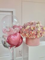 150-rose dome with gold butterflies next to a birthday bubble balloon and pink heart balloons