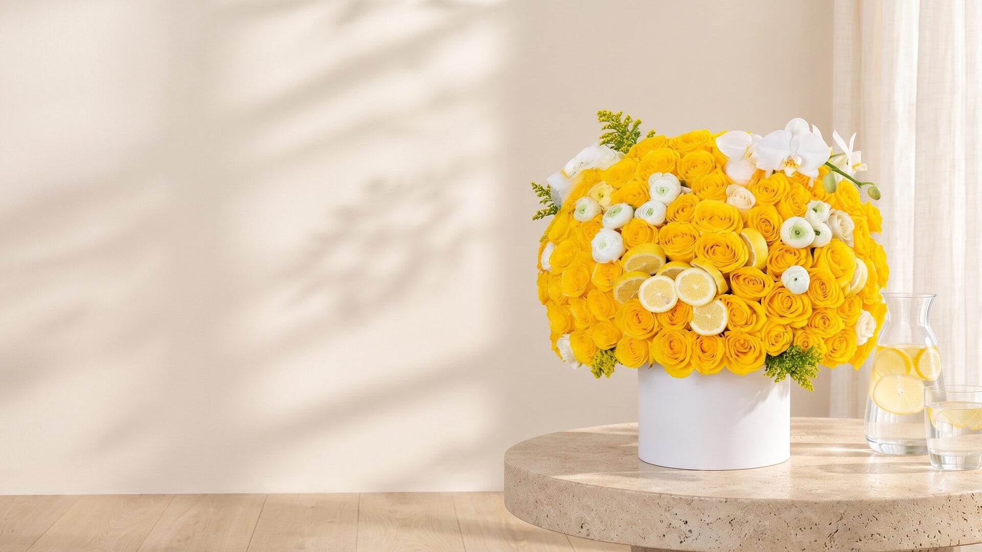 Limoncello Luxe Hat Box by My Divine Decors: yellow roses, white ranunculus and lemon slices on a stone table in a sunlit Miami room